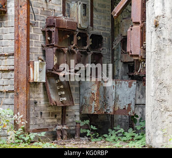 weathered rusty industrial detail including old corroded electric control cabinets Stock Photo