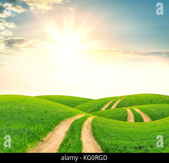 Sunset over dirt road Stock Photo