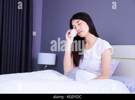 woman is crying on bed in the bedroom Stock Photo