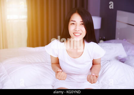 happy woman on bed in the bedroom Stock Photo