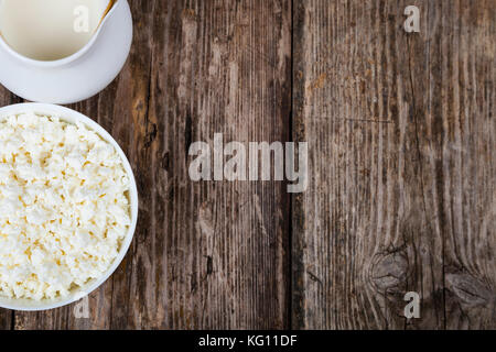 Cottage cheese and milk on a wooden table. Healthy dairy products. Stock Photo
