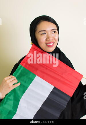 Muslim woman with the United Arab Emirates flag Stock Photo