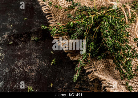 Bunch of fresh organic thyme on an old metallic rusty black background, copy space Stock Photo