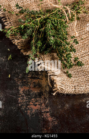 Bunch of fresh organic thyme on an old metallic rusty black background, copy space Stock Photo