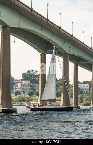 Sailboat passing under the Naval Academy Bridge on the Severn River near the US Naval Academy in Annapolis, Maryland USA Stock Photo