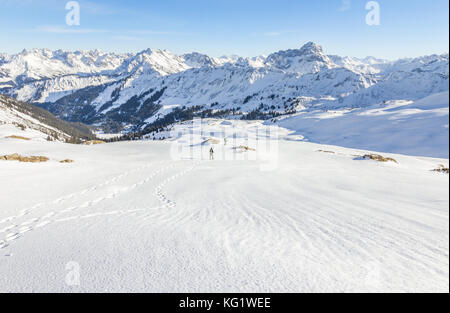 Senior couple is snowshoe hiking in alpine winter mountains. Bavaria, Germany. Stock Photo