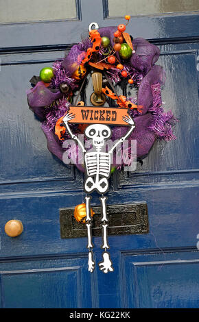 halloween wreath hanging on house front door Stock Photo