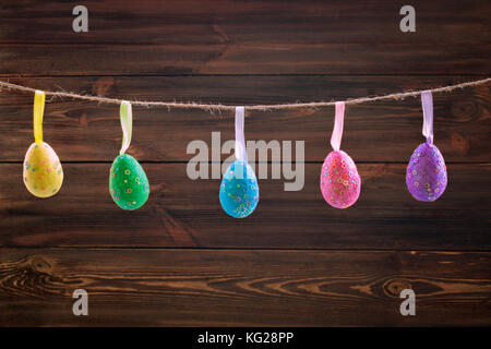 Easter holiday background with eggs decorations hanging on rope Stock Photo