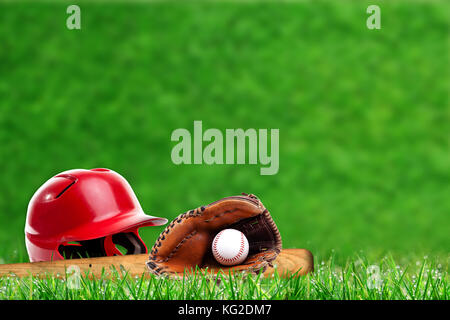 Low angle view of baseball equipment on field with close up dew on grass and deliberate shallow depth of field on background with copy space. Stock Photo