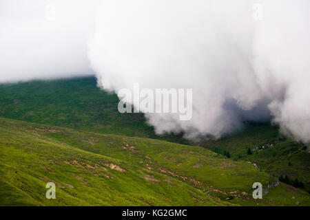 Clouds rolling over a mountain before the storm. Stock Photo