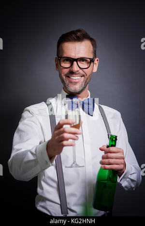 Elegant man with bottle of champagne and champagne flute Stock Photo