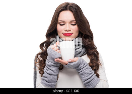 woman in warm clothes smelling coffee Stock Photo