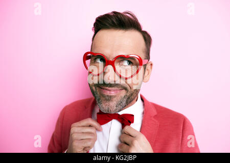 Man in tuxedo tying bow tie Stock Photo