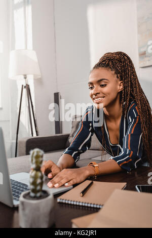 woman using laptop on couch Stock Photo
