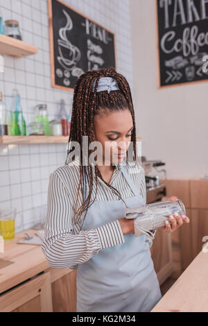barista wiping glass with towel Stock Photo