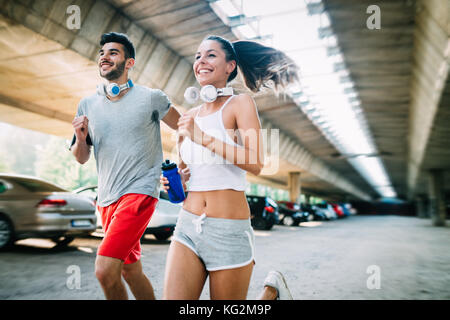 Attractive man and beautiful woman jogging together Stock Photo