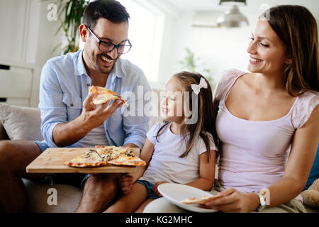 Happy family sharing pizza together at home Stock Photo