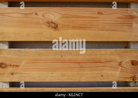 Close up background of fence made from wooden planks of light color that have cracks between each other. Stock Photo
