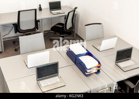 Modern office space, with desks and laptops. Stock Photo