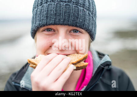 Thursday  02 November 2017 A 11,12,13, year old girl eats a healthy sandwich outside Stock Photo