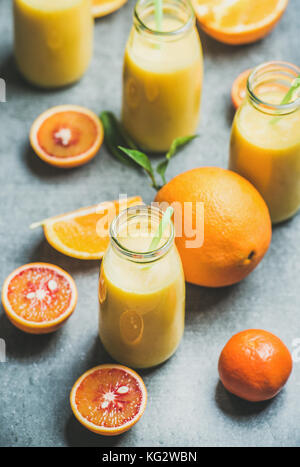 Healthy yellow smoothie in bottle over concrete background Stock Photo