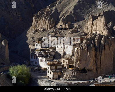 Mountain village of Lamayuru, white houses stand among high vertical rocks, are lit by the rays of the setting sun, Ladakh, the Himalayas, Northern In Stock Photo