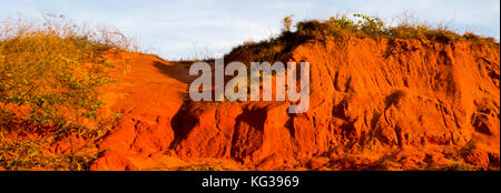 Setting sun highlight the rocks at  Gantheaume Point, a red-sandstone headland that juts out into the Indian Ocean near beautiful Cable Beach, Broome. Stock Photo