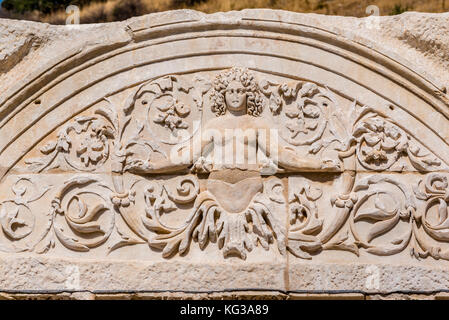 Marble reliefs in Ephesus historical ancient city, in Selcuk,Izmir,Turkey.Figure of Medusa with ornaments of Acanthus leaves,Detail of the Temple of H Stock Photo