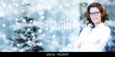 christmas theme, business smiling woman on blurred bright lights background, banner template with copy space Stock Photo