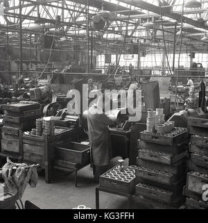 1950s, historical, male workers at machines repairing or retreading ...