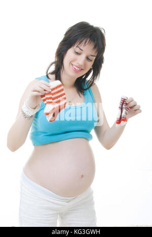 pregnant mother looking for baby socks Stock Photo