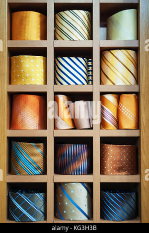 Neckties showcase at store. Collection of coiled neckties in display Stock Photo
