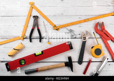 DIY construction tools for home improvement on white wooden background Stock Photo