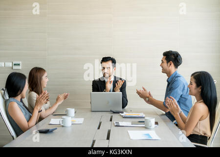 Hands of business partners applauding to reporter after listening to presentation at meeting. Stock Photo