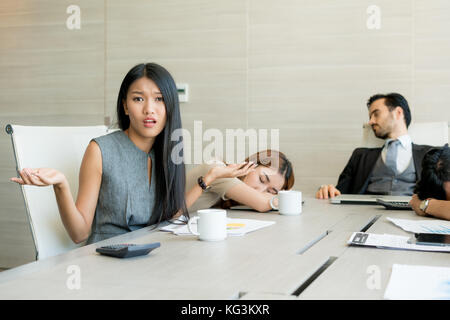 Bored business people and sleeping resting on workplace during work meeting, concept of exhausted businesspeople bored sleep tired. Stock Photo