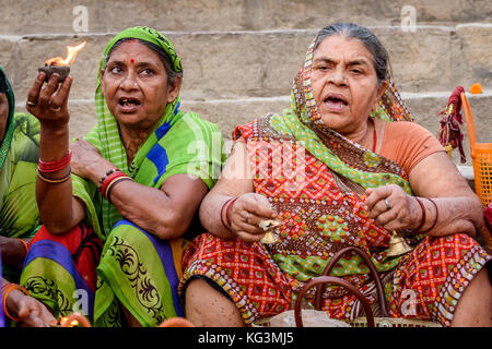 Hindu women holding  clay oil lamp with sacred fire for offering in the Ganges river at Varanasi ghat. Stock Photo