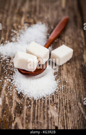 Wooden spoon with sugar on an old wooden background Stock Photo