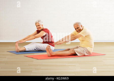 Senior couple doing stretching exercise Stock Photo
