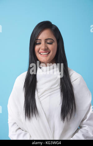 Woman wrapped In white dupatta eyes closed Stock Photo