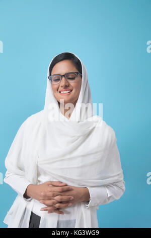 Woman wrapped In white dupatta Stock Photo