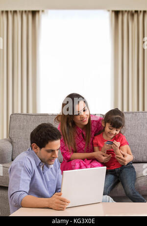 Family using credit card for shopping online Stock Photo