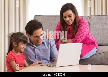 Family using credit card for shopping online Stock Photo