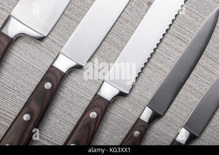 set of high quality kitchen knives  on wooden table Stock Photo