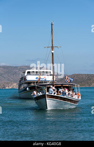 The Spinalonga Island ferry returns with passengers to the resort of Elounda, Crete, Greece. October 2017 Stock Photo