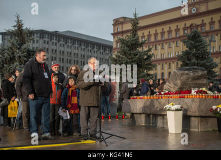 Veteran human rights activist Sergei Kovalyov reading the names of people killed in the Communist era. He was one of more than 5,000 people who took part in a ceremony in Moscow's Lubyanka Square on October 29, 2017, to commemorate the victims of political terror. For twelve hours, people read names of those who were killled or disappeared, especially at the height of Stalinist terror in 1937-1938. In Moscow alone, more than 30,000 people were murdered. Reading the names of the victims has become an annual tradition since 2007. Stock Photo