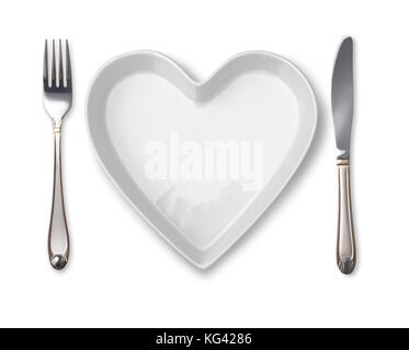 plate in shape of heart, table knife and fork isolated on white Stock Photo