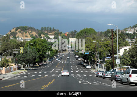 Wide street scene and hill hills cars on road in Highland Park area of LA  Los Angeles, California US  USA   KATHY DEWITT Stock Photo