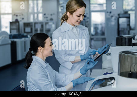 Delighted positive women working in team Stock Photo