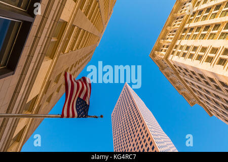 Bottom view of office skyscrapers and the flag of USA on the background of clear sky, Atlanta Stock Photo