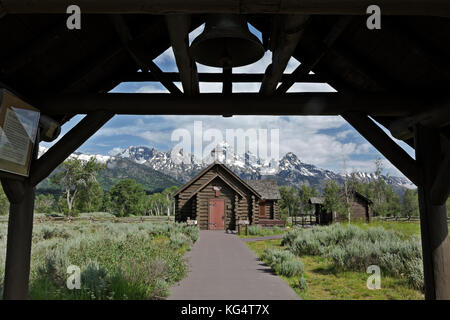 WY02534-00...WYOMING - Chapel of the Transfiguration, a small, historical log church in Grand Teton National Park with the Grand Teton behind. Stock Photo